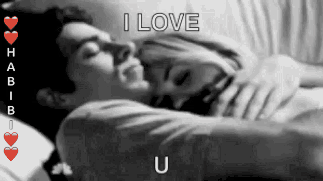 a black and white photo of a man and woman hugging with the words " i love u " on the bottom