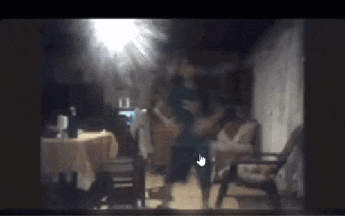 a blurry picture of a woman dancing in a room