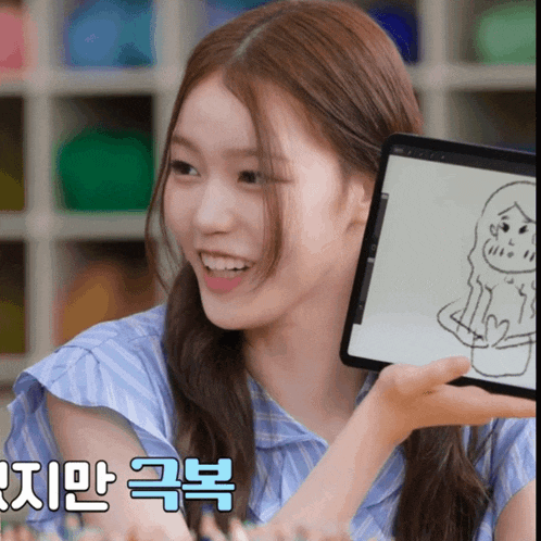 a woman holds up a tablet with a drawing of a woman on it