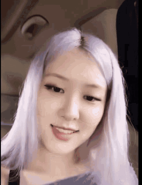 a close up of a woman 's face with purple hair