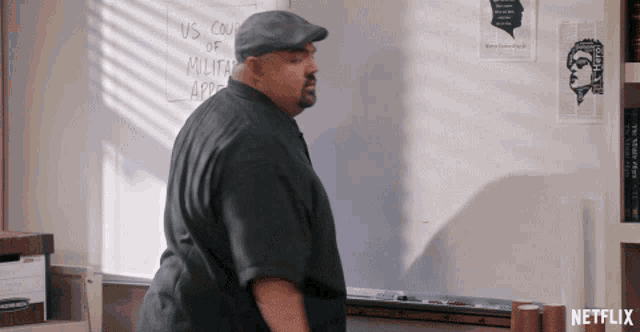 a man stands in front of a white board that says us court of military appeals