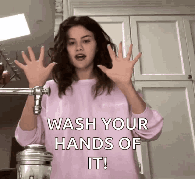 a woman in a pink sweater says to wash your hands of it