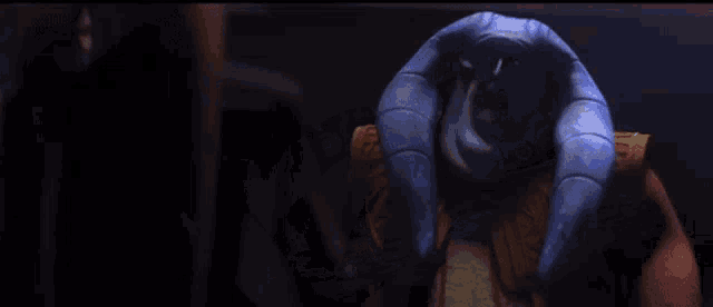 a cartoon character is standing in a dark room with his hands covering his face .