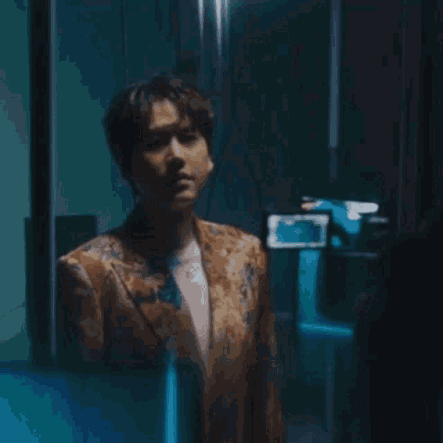 a man in a blue suit is hanging upside down in a room .