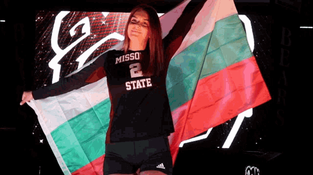missouri state volleyball player holding a flag