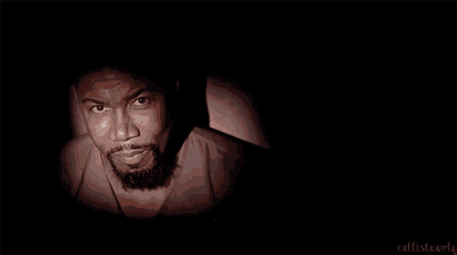 a man is looking at a screen in a dark room .