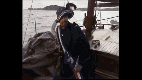 a man standing on a boat in the water