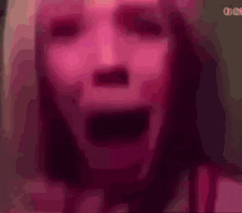 a blurred image of a woman 's face with a sign in the background that says " dos "