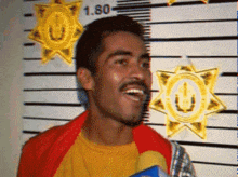 a man is smiling in front of a police line up with the number 1.80