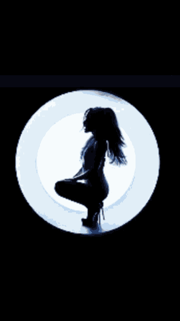a silhouette of a woman kneeling in a circle