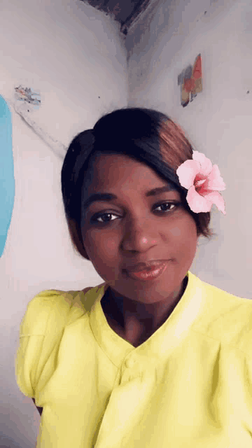 a woman with a pink flower in her hair