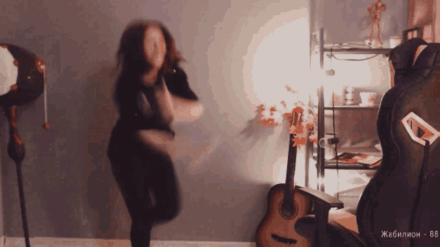 a woman is dancing in front of a guitar with the number 88 written on it