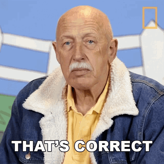 an older bald man with a mustache is wearing a denim jacket and says that 's correct
