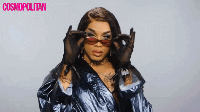 a woman wearing sunglasses and gloves with the word cosmopolitan in the corner
