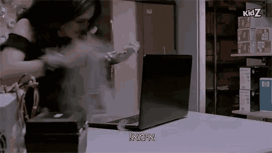 a woman is standing in front of a laptop that says kidz