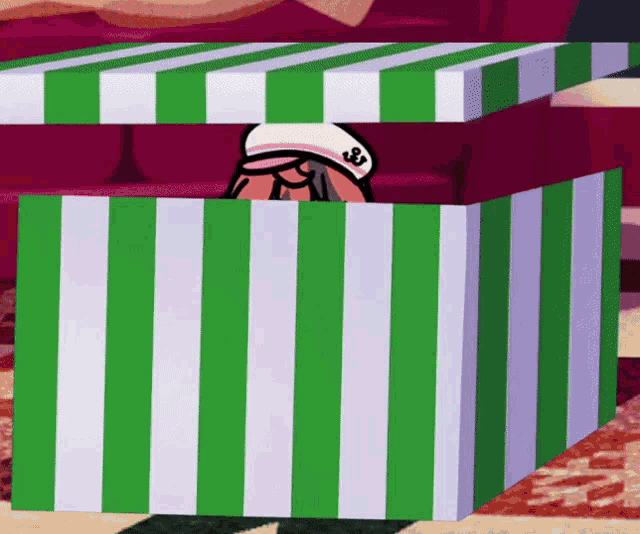 a green and white striped box with a cartoon character inside of it