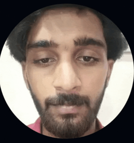 a close up of a man 's face with a beard and a red shirt .