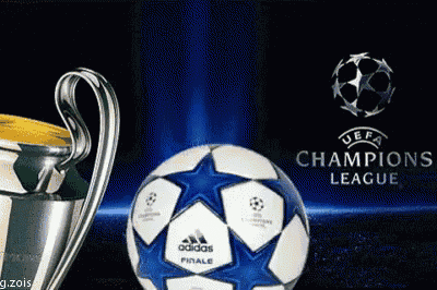 a trophy and a soccer ball with the champions league logo behind them