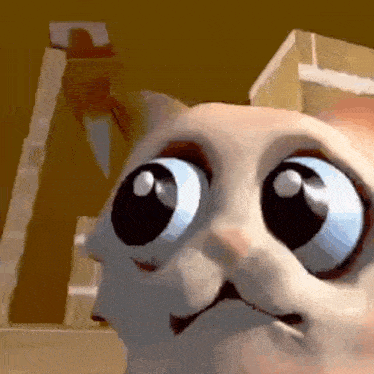 a close up of a cartoon cat with big blue eyes looking at the camera .