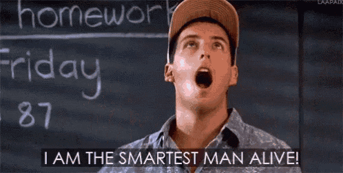 a man is standing in front of a blackboard with his arms outstretched and says `` i am the smartest man alive ''