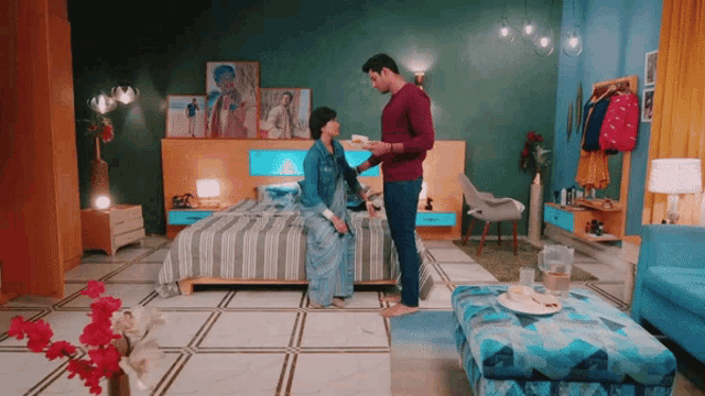 a man standing next to a woman in a room