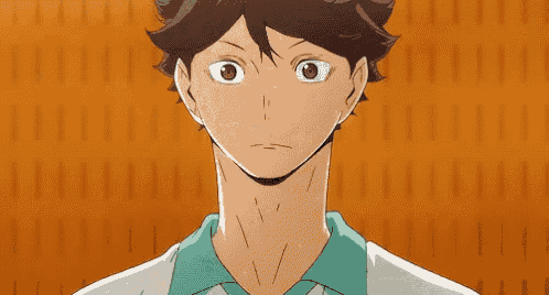 a close up of a cartoon character 's face with a green shirt on against an orange background .