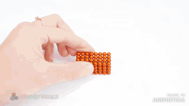 a person is playing with a set of magnet beads