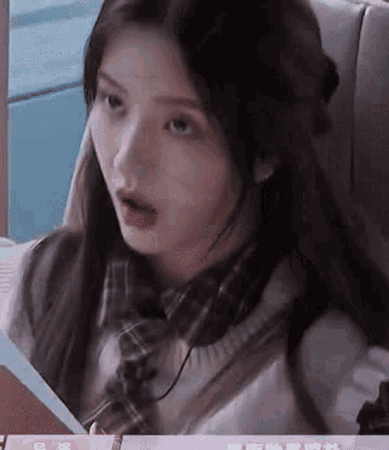 a close up of a woman 's face while sitting in a chair .