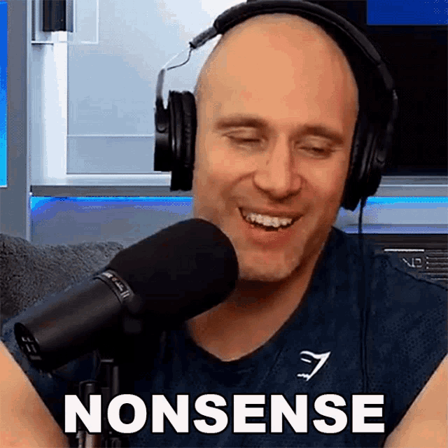 a bald man wearing headphones is smiling in front of a microphone and the word nonsense is on the bottom