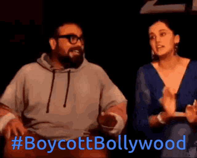 a man and a woman sitting next to each other with #boycottbollywood written in blue letters