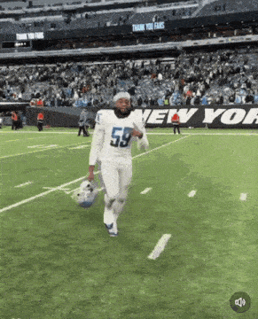 a football player with the number 59 on his jersey runs on the field