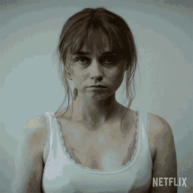 a woman in a white tank top with a netflix logo on the bottom