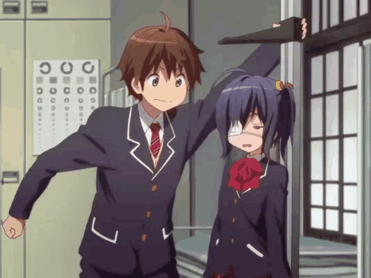 a boy and a girl are standing next to each other in front of a sign that says ' o ' on it