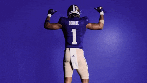 a football player in a purple uniform with the number 1 on the back