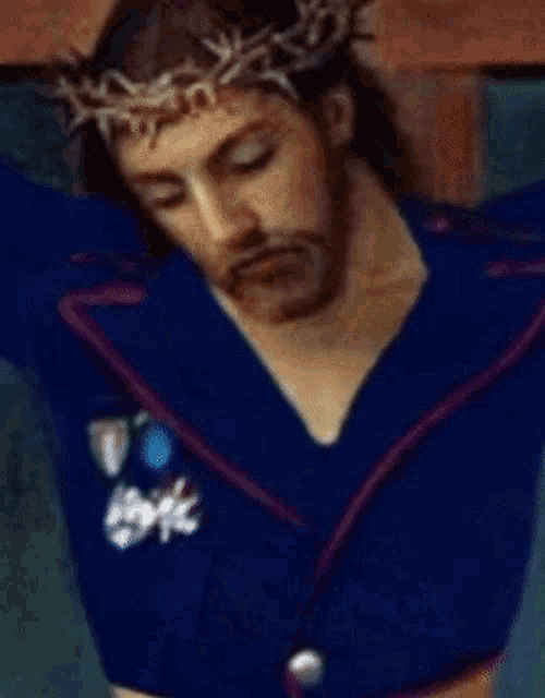 jesus wearing a blue jacket and a crown of thorns is on the cross