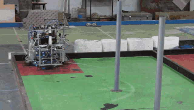 a robot is sitting on a green carpeted floor