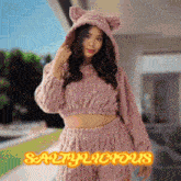a woman wearing a pink cat costume with the words saltylicious on the bottom right