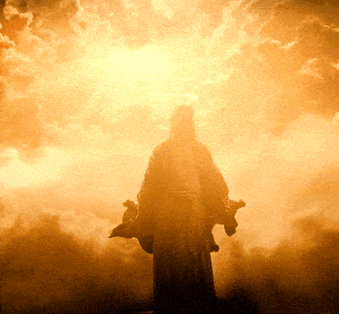 a statue of jesus in a cloudy sky with the sun behind him
