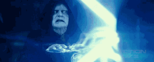a man in a hood is holding a lightning bolt in his hands .