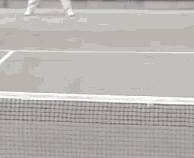 a woman is playing tennis on a court with a sign that says women 's open