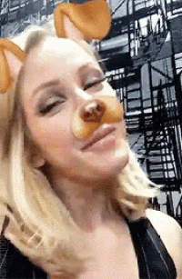 a woman is wearing a dog mask on her face and making a funny face .