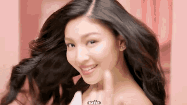 a close up of a woman 's face with the word maddie on the bottom left