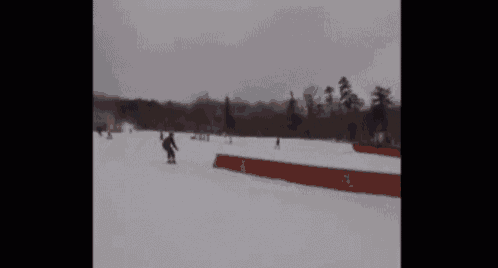 a person is sliding down a snowy hill