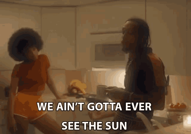a man and a woman in a kitchen with the words we ain 't gotta ever see the sun