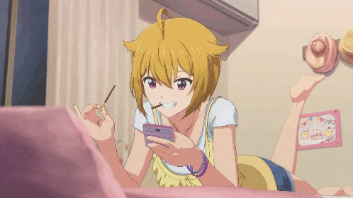 a girl is laying on her stomach eating a snack