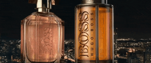 two bottles of hugo boss perfume are on a city background