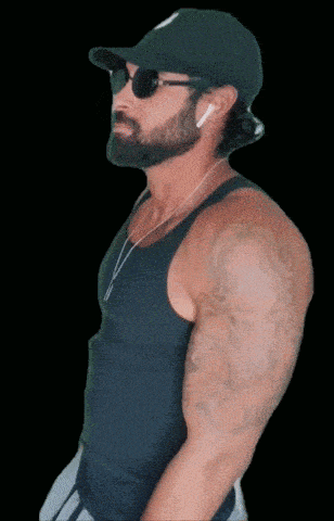 a bearded man wearing a hat and sunglasses