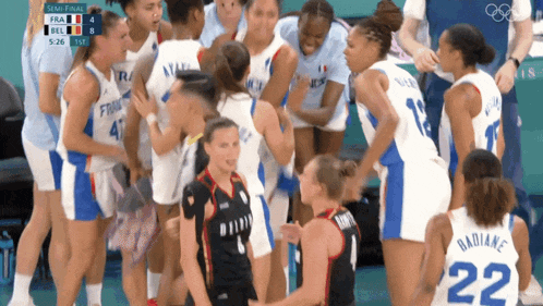 a group of female basketball players are huddled together and one has the number 22 on her back