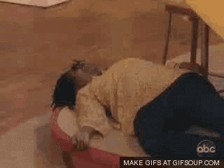 a woman is laying on the floor with her head on a pillow .