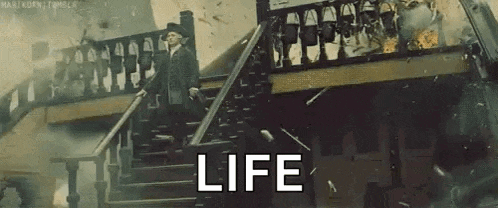 a man in a suit is walking down a set of stairs with the word life written on them .